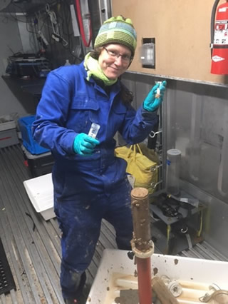 Katja in the cold lab (4°C), working on a 30 cm long sediment core from the seafloor